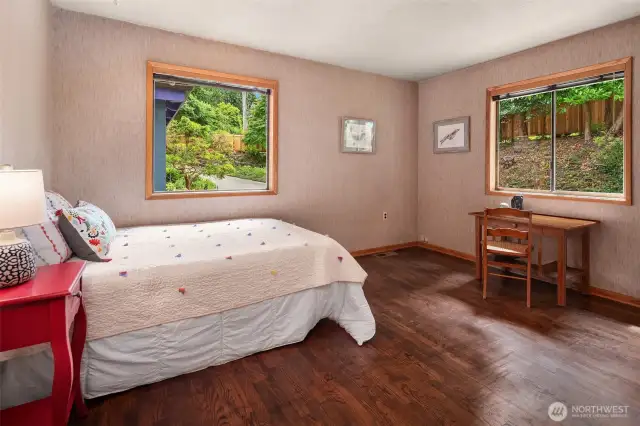 One of the two bedrooms on the main level. Current owners used this as an office. Note the lovely hardwood floors and windows on two sides.