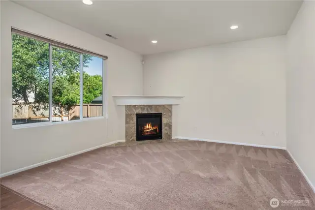 Spacious living room with corner gas fireplace