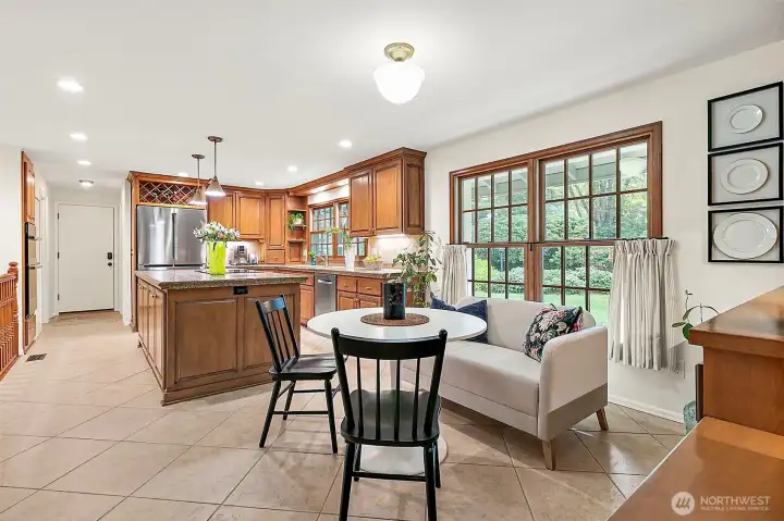 Casual dining area off the kitchen featuring large windows that frame a lovely view and fill the space with natural light.