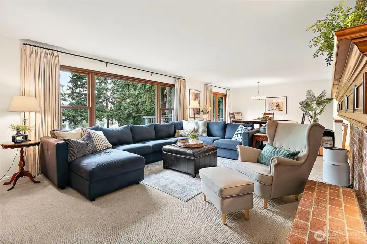 The expansive picture windows beautifully capture serene views of the lake, filling the home with natural light and creating a seamless connection between the indoors and the stunning outdoor setting.  This home has a large living and dining room with an open layout, perfect for large gatherings or everyday living.