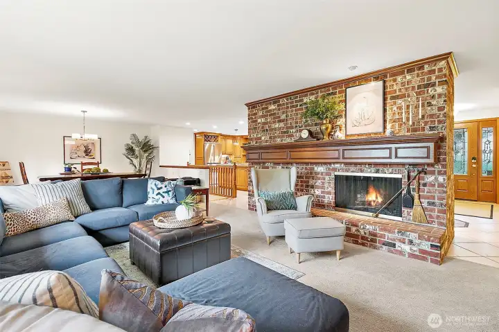 Stunning floor-to-ceiling brick wood burning fireplace creating a warm and inviting focal point.  The carpet was  replaced in 2023.