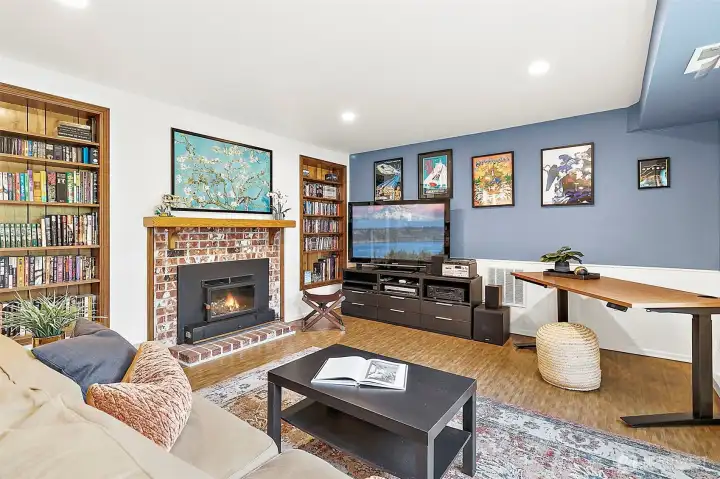 This inviting basement MIL suite features warm bamboo flooring and offers a comfortable living room, eat-in area, and cozy fireplace. Large windows fill the space with natural light and frame views of the surrounding greenery.