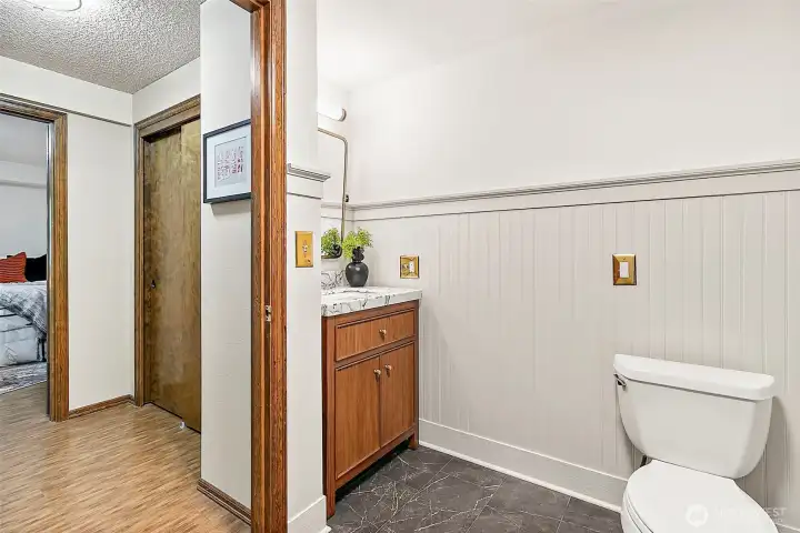 Updated 3/4 bath downstairs includes new vanity, with granite countertop mirror, lighting tile flooring and beadboard installed for a finished look.