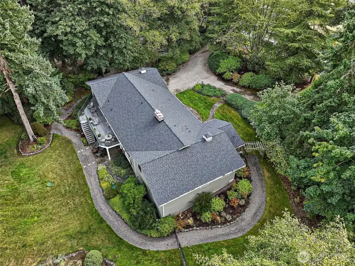 Nestled on a sprawling 68,824 sq. ft. level lot, this property offers exceptional outdoor living with a newly added gravel path and lush, mature landscaping. The circular driveway provides an impressive welcome and can easily accommodate 10+ vehicles, making it perfect for entertaining or gatherings. A new composition roof installed in 2024 ensures peace of mind and long-lasting durability, while the home’s setting combines privacy, convenience, and timeless curb appeal.