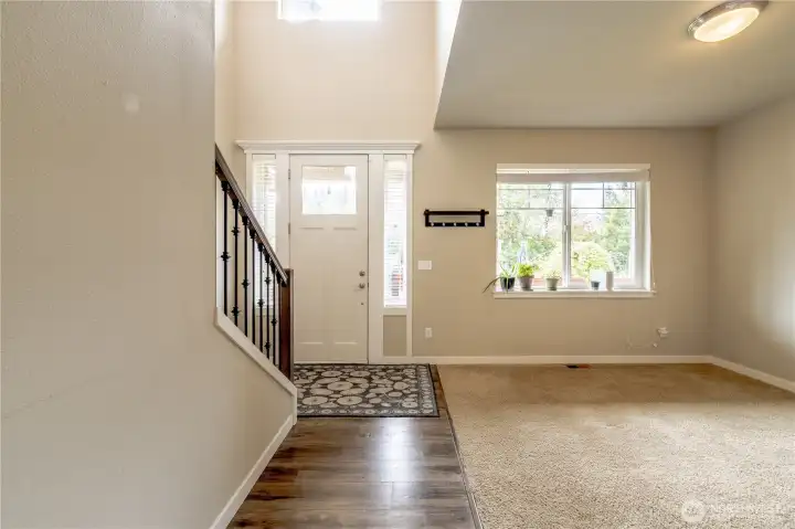 Facing the front door, the Living room is a Versatile Bonus space Bursting w/Natural Light