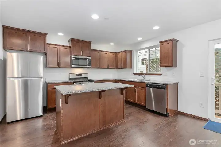 Feeling more casual, pull a stool up to the bar on the kitchen island.