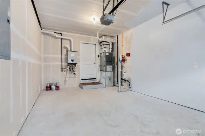 Clean and tidy garage with tankless, on-demand water heater and furnace.