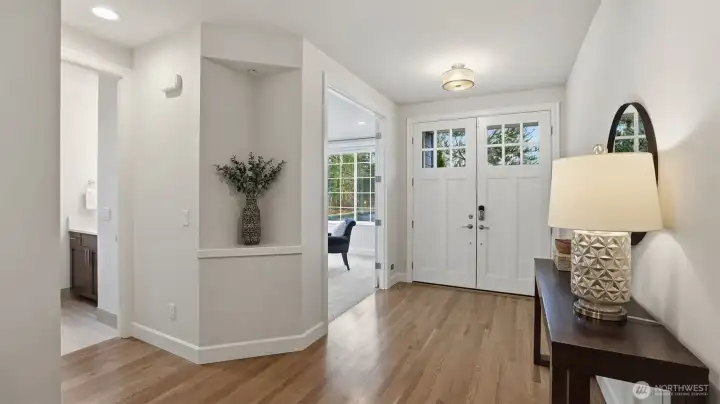 Gleaming floors and architectural details highlight the north facing entry.