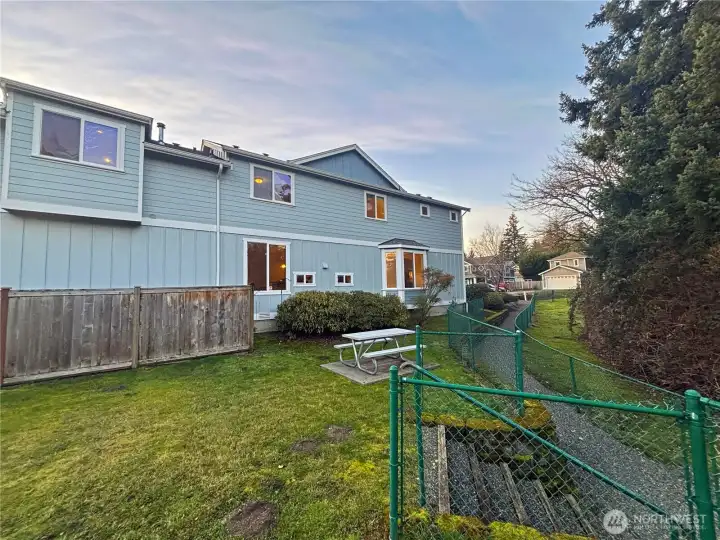 Follow the walking path just out front leading to the Community park the neighbors the property. Has metal picnic table and athletic court with basketball hoop.