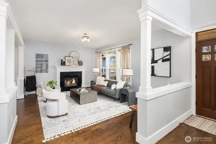 Main floor living room with gas fireplace, adjacent to dining room