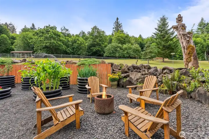 Fire pit and raised gardens.