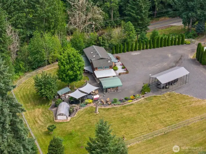 Aerial of home, pond, and fenced 10 acres.