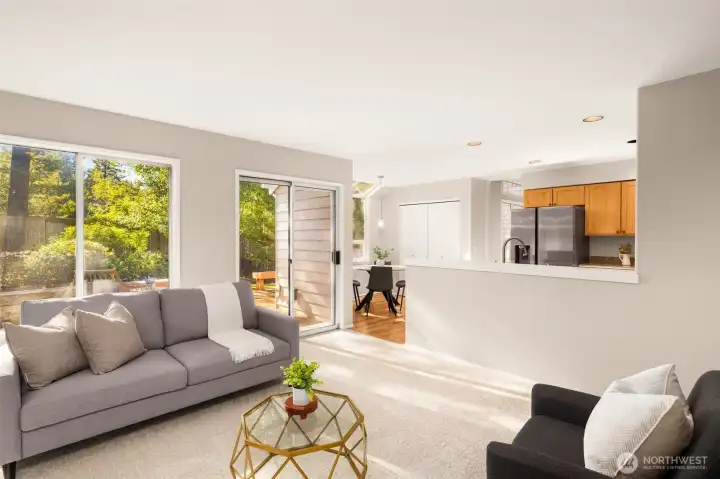 Kitchen overlooks family room and patio door to backyard