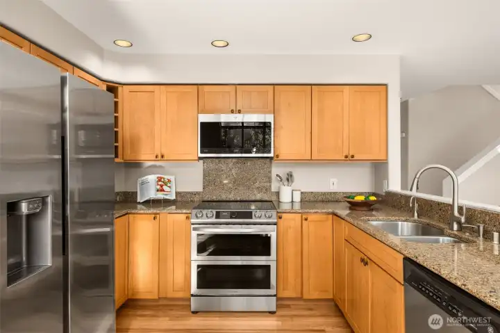 This beautifully designed kitchen features soft-close shaker cabinets, a pull-out spice cabinet, and convenient Lazy Susan corner storage for maximum functionality. High-end stainless appliances including induction for highly efficient and precise temperature control.