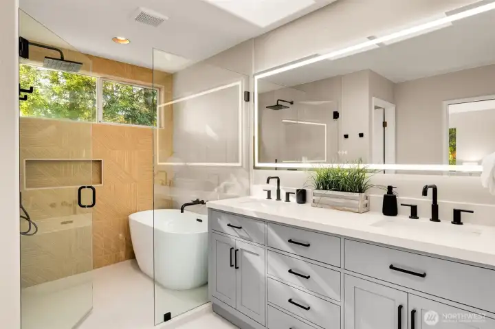 Fully renovated in 2026, this luxurious primary bath features a quartz vanity with soft-close drawers, LED backlit mirror, and stunning floor-to-ceiling tile surround. The curbless walk-in shower with a linear drain and rain showerhead creates a true spa-like retreat.
