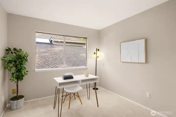 1 of 3 spacious bedrooms, currently staged as an office