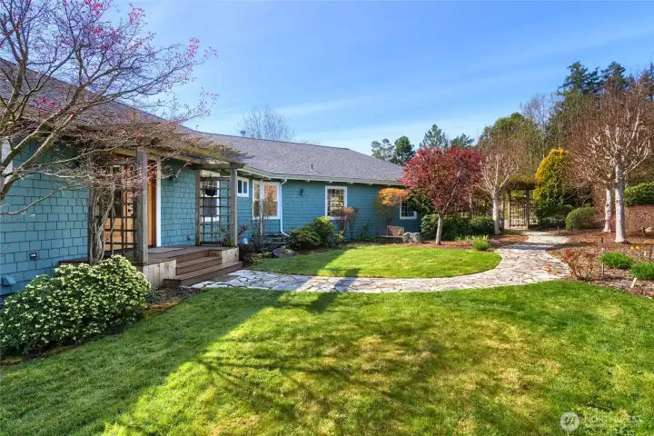 Newer roof and established trees line the property