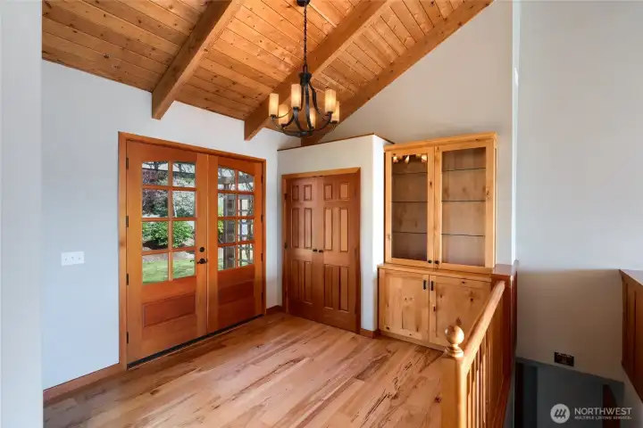 Spacious foyer with gorgeous, fir front door with pane windows