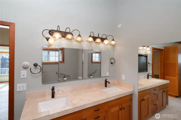 Primary bath has 2 vanities, granite tile counters and fir cabinets