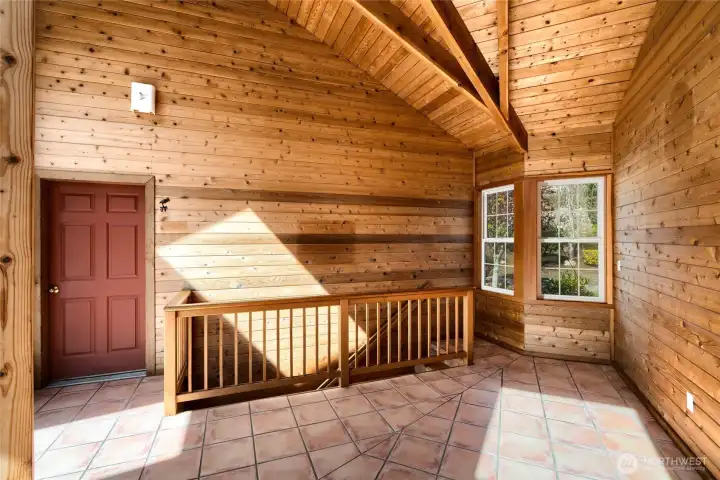 Bright, fully lined with pine  Atrium leads to one of two staircases to lower level or garage
