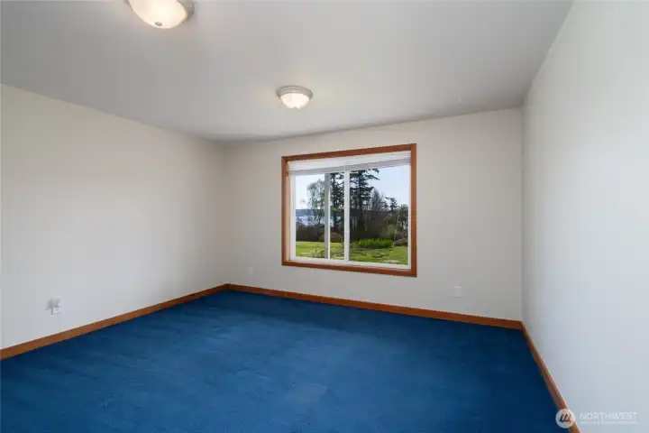 large bedroom in lower level with water view