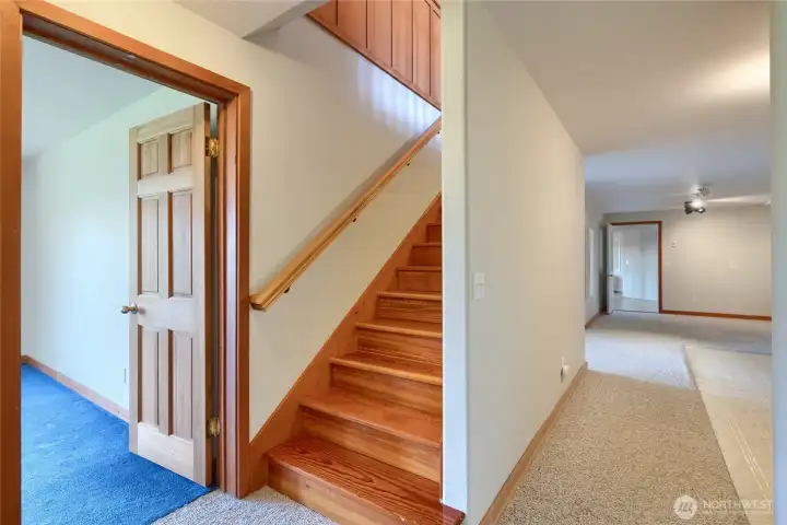 2nd of 2 staircases leads to lower level bedrooms and laundry area
