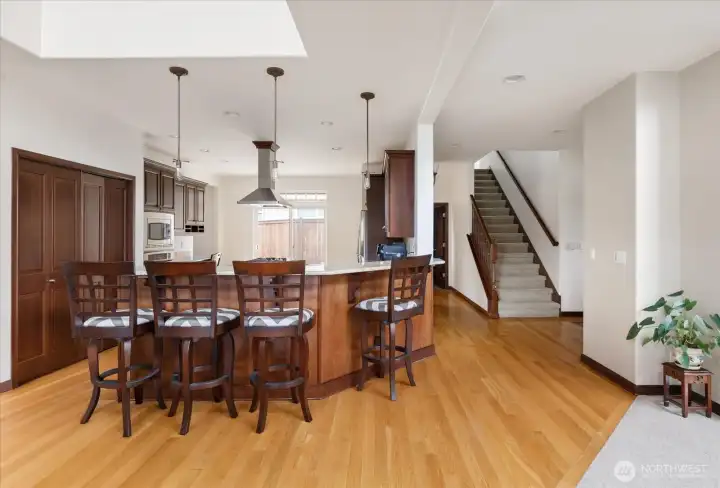 Hardwood flooring in the entry, kitchen and dining room area, and an open floor plan.