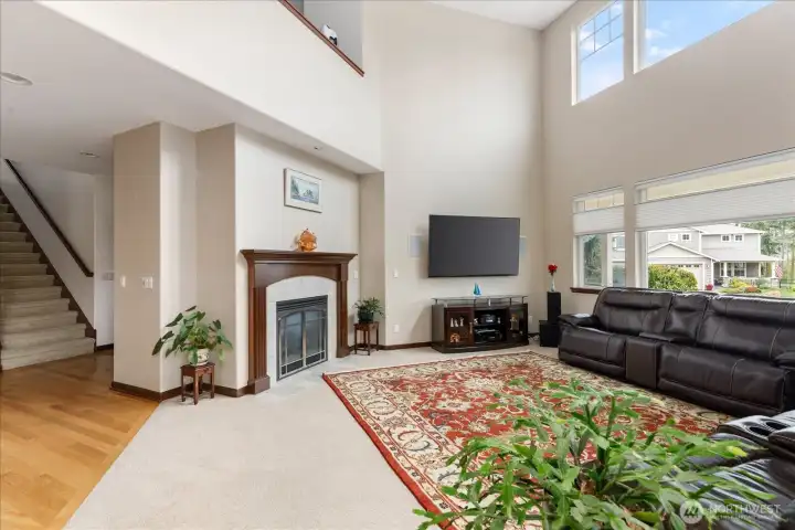 Living room has a very high vaulted ceiling with plenty of windows that make it very light & bright.