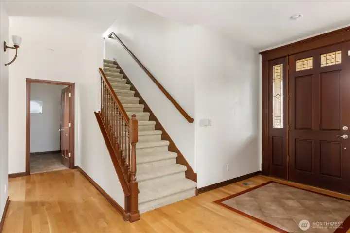 The stairway next to the front door leads to the Upper Level of the home. Doorway to the left heads into the utility/laundry room.