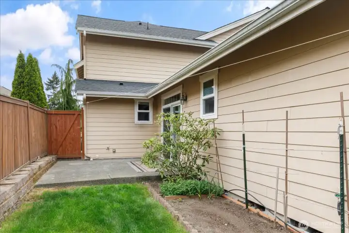 From the Kitchen sliding doors, you step out on to a patio area, and the gate goes to the front yard.