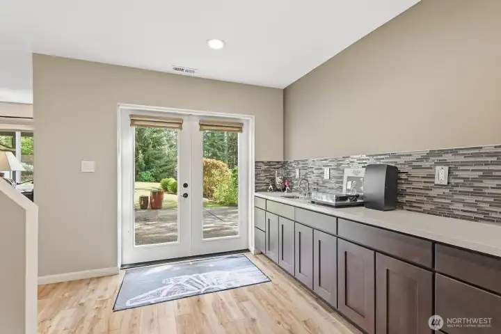 Lower Level with kitchenette and French doors out to a patio and the backyard.