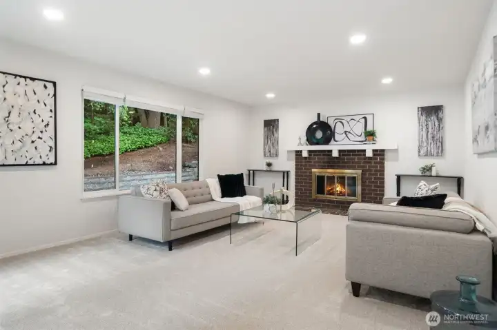 Recreation Room off kitchen with fireplace, fresh paint, canned lighting, generous windows and easy access to back deck for level out entertaining