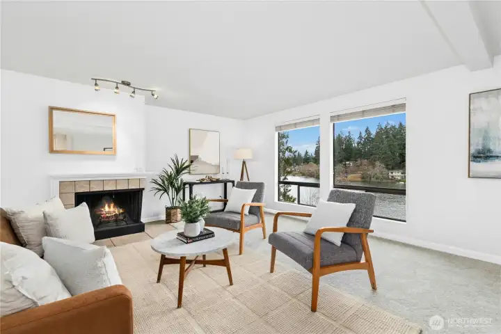 Sun-drenched, cozy fire, and endless lake view from this spacious living space.