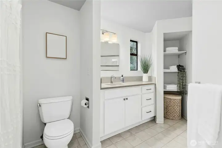 updated main bath with new lighting, counters, floors and linen closet