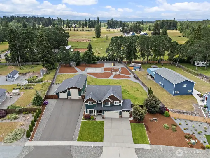 Beautifully Manicured Grounds Easily Maintained w/ by Front & Backyard Sprinkler System! Fresh Landscape Bark, New Asphalt Driveway Leads to the Large Dual Bay Heated Shop!