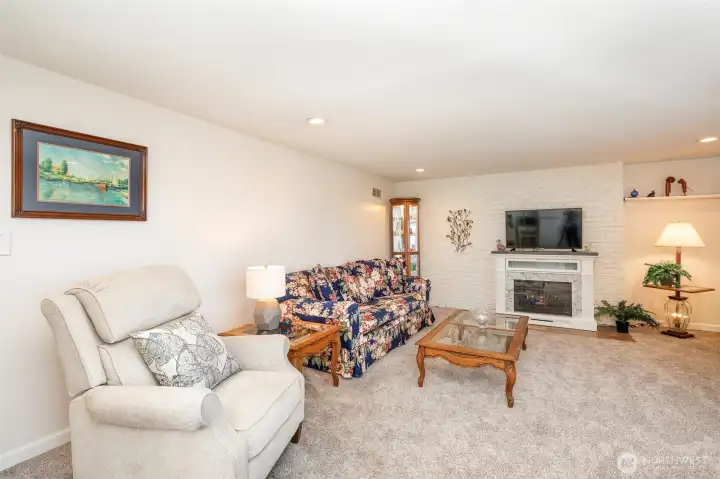 This is the lower level  living room space electric fireplace  new carpet and paint