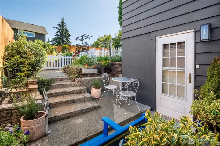 from the main level down to the carport entrance-exit also leads to the private garden area & another entertaining patio space
