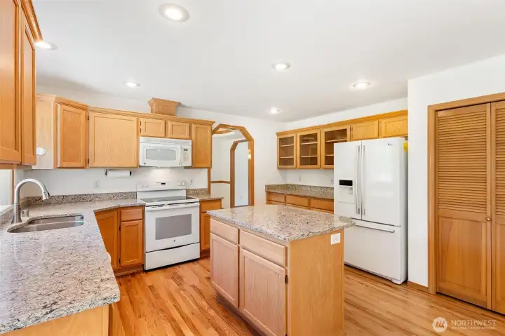 A true chef’s kitchen featuring ample cabinetry, a center island, and plenty of prep space for entertaining. A true chef’s kitchen featuring ample cabinetry, a center island, and plenty of prep space for entertaining.