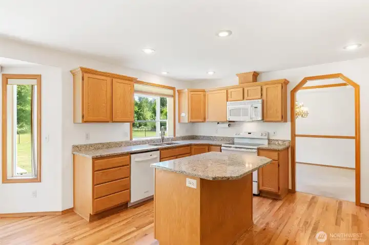 View from the kitchen into the dining area, showcasing the open and flowing floor plan. View from the kitchen into the dining area, showcasing the open and flowing floor plan.