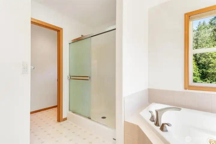 Relaxing primary bath featuring a deep jetted soaking tub and separate glass-enclosed shower, separate water closet for added privacy. Relaxing primary bath featuring a deep jetted soaking tub and separate glass-enclosed shower, separate water closet for added privacy.