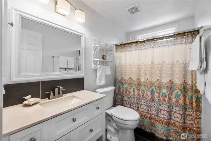 Tastefully update full hall bathroom for guests and the 2 other bedrooms. Notice the new window near the shower.