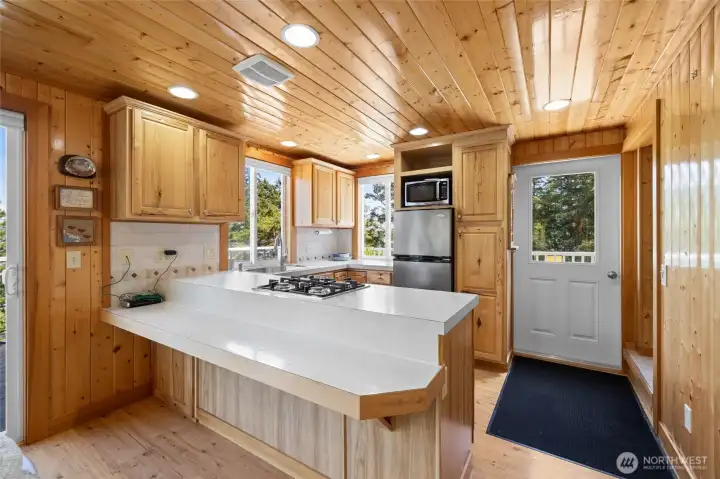Propane cooktop, stainless appliances. Eating bar could be set up with stools for casual dining.