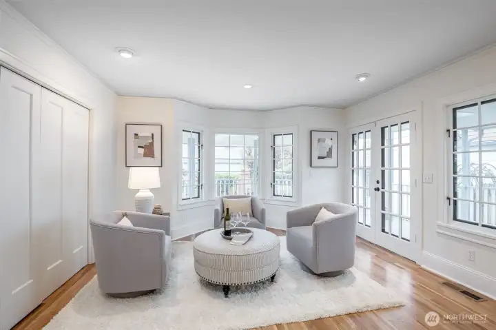 Full of windows, this bright corner of the family room leads out to the covered deck.