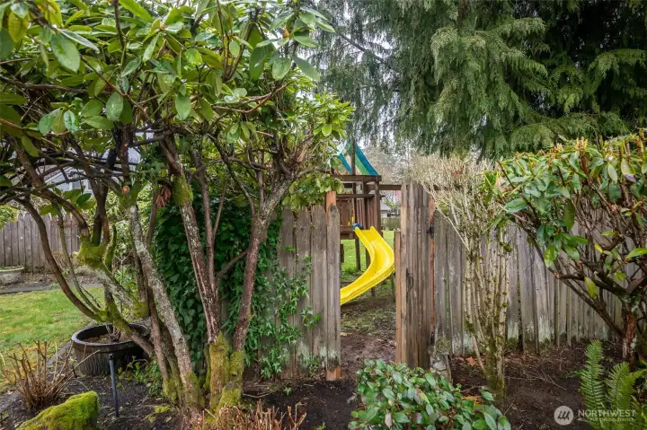This back gate leads to an enclosed play field with access only from neighboring homes.