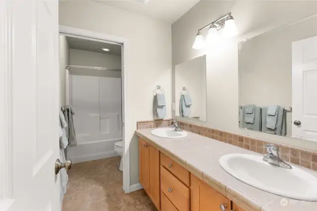 Guest bath has double sinks, and a separated section for the shower/tub and toilet. No one gets slowed down getting ready in the morning in this house because someone else is in the shower!
