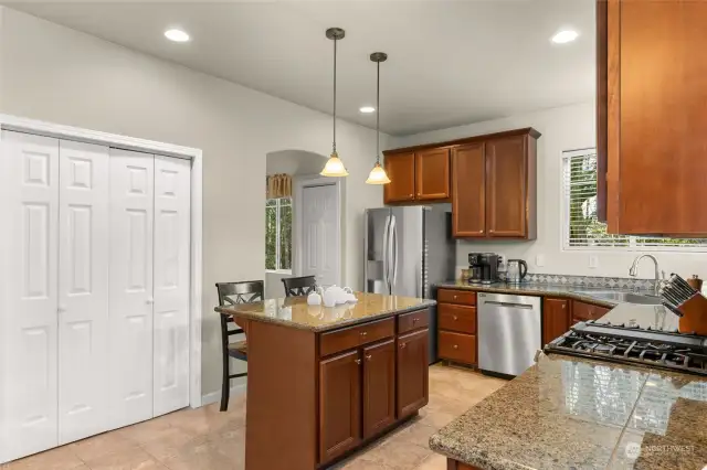 The kitchen boasts brand-new smart stainless steel appliances with Wi-Fi capability, granite countertops, and solid wood cabinetry. The addition of a central island makes this space both functional and stylish, creating the perfect setting for preparing and enjoying delicious meals.