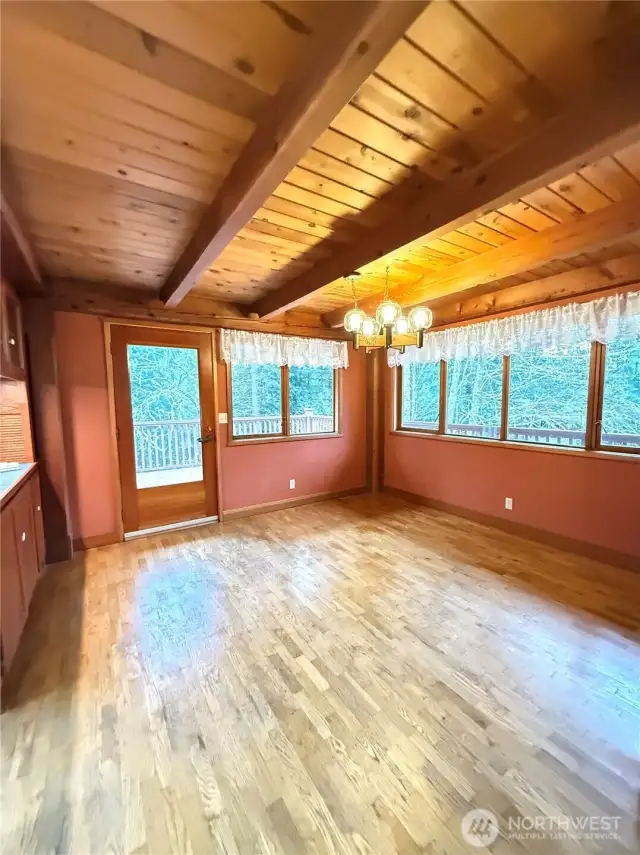 Dining room steps out onto layered deck