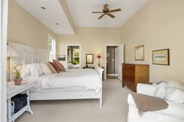 As you step back into the main floor primary bedroom, you'll find the entrance to the private ensuite bath on your left.
