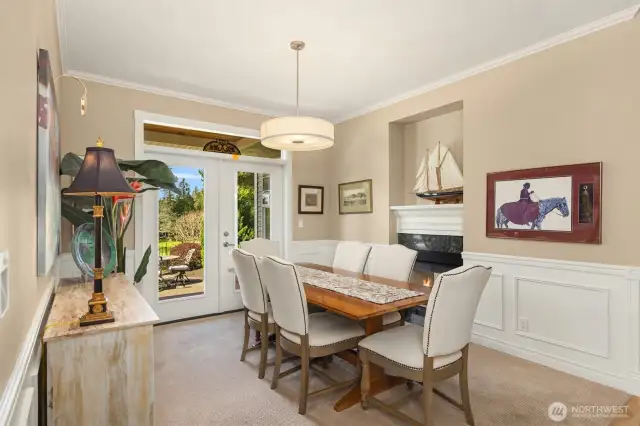 The spacious yet intimate dining room is enhanced by the two-sided fireplace shared with the living room. French doors open directly to the patio and deck, creating a seamless connection to the beautiful outdoor views.