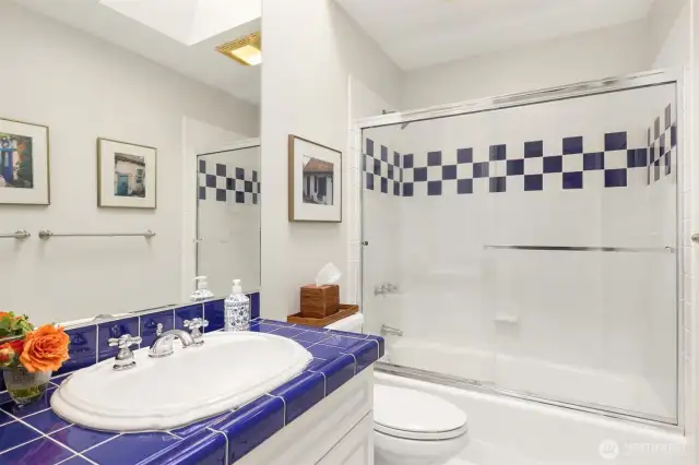 The upstairs bathroom is shared by the three bedrooms and includes a tub/shower combination, offering both functionality and convenience for family or guests.